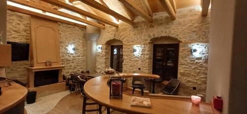 a room with a table and chairs in a building at Casagli Luxury Suites in Dimitsana