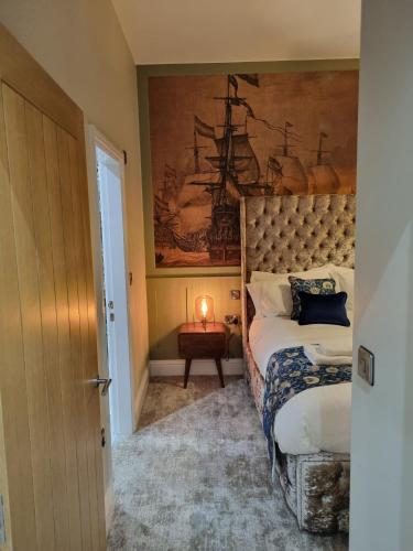 a bedroom with a bed and a painting on the wall at The Resolution Hotel in Whitby