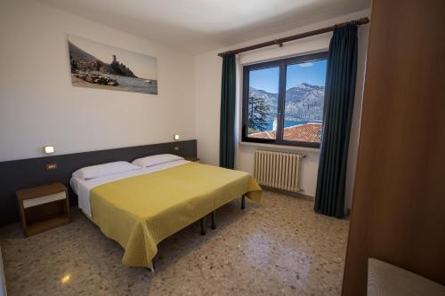 a bedroom with a bed and a large window at La Madrugada in Malcesine