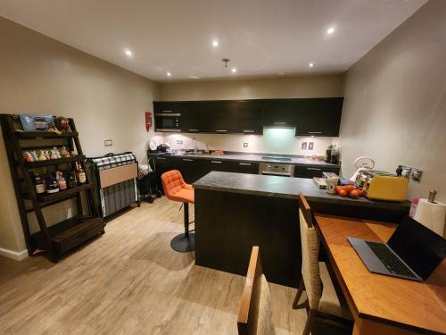 a kitchen with a table and a counter top at Joyful Abode - Live in the Heart of Manchester in Manchester