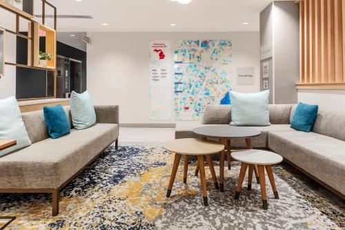 a waiting room with two couches and two tables at TownePlace Suites by Marriott Chesterfield in Chesterfield