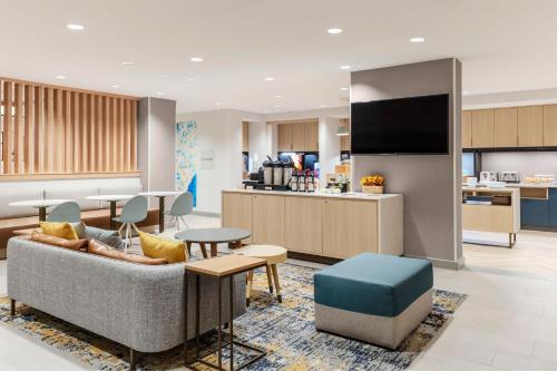 a living room with a couch and a kitchen at TownePlace Suites by Marriott Chesterfield in Chesterfield