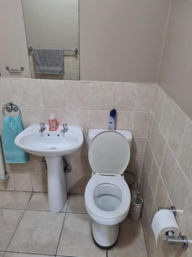 a bathroom with a toilet and a sink at FALET ACCOMMODATION in Midrand