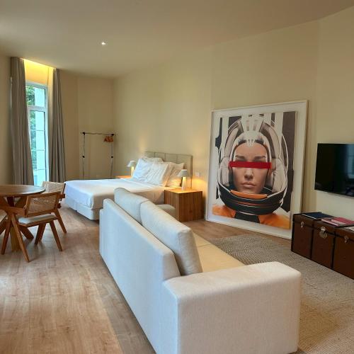 a room with two beds and a couch and a television at Downtown collection apartments II in Funchal