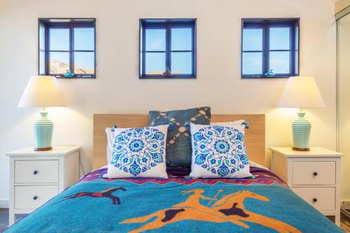 a bedroom with a bed with two night stands and two lamps at Morongo Star Ranch - Rolling Country Hills w Pool in Morongo Valley