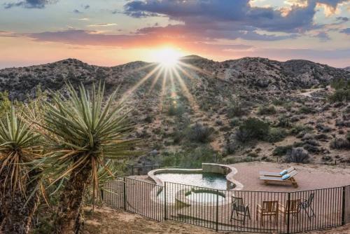 a view of the desert from a house with a sunset at Morongo Star Ranch - Rolling Country Hills w Pool in Morongo Valley