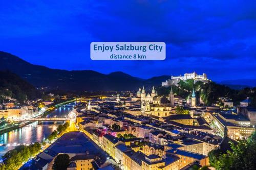an aerial view of a city at night at Mountain View Salzburg - SELF CHECK-IN - Apartments in Grödig