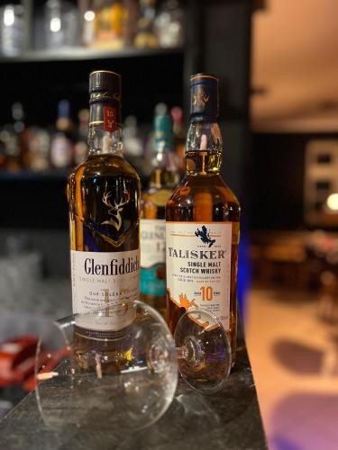 two bottles of whisky sitting on a table at Upper-House Goldener Hirsch in Aystetten