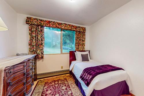 a bedroom with a bed and a window at Pacific Prairie in Woodinville