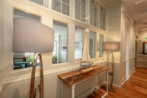 a home office with a desk and a lamp at The Golden Lion Hotel in Hunstanton