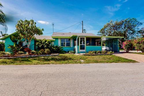 a blue house with a driveway in front of it at Bayfront Bliss Retreat in Marco Island