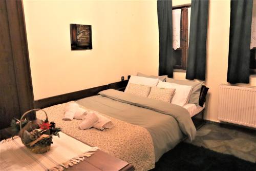 a bedroom with a bed and a table with a basket on it at Gaea Mont Chalet in Palaios Agios Athanasios
