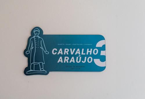 a sign for a bar with a statue of a woman at City Hall Apartments in Vila Real