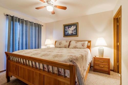 a bedroom with a bed and a ceiling fan at Walk-in Eagles Nest Condo with Pool and Hot Tub near Silver Dollar City in Branson
