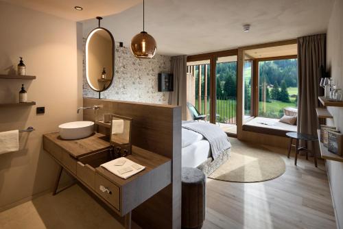a bedroom with a bed and a sink and a mirror at Badia Hill in Badia