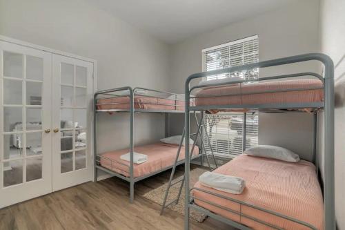 a room with two bunk beds and a window at Frisco Spacious & Cozy Bling Home by Aya in Frisco