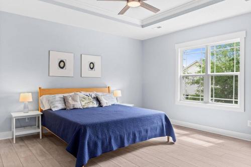 a white bedroom with a bed and a window at Live Oak Villa~OKI Beach Retreat in Oak Island