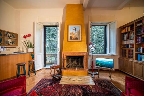 uma sala de estar com lareira e televisão em Villa Elvira 1931 em Siena