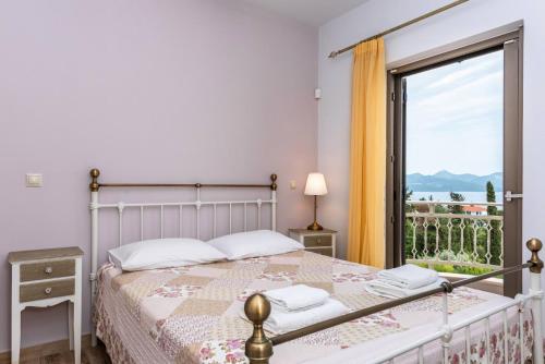 a bedroom with a bed and a large window at House 55 in Arta
