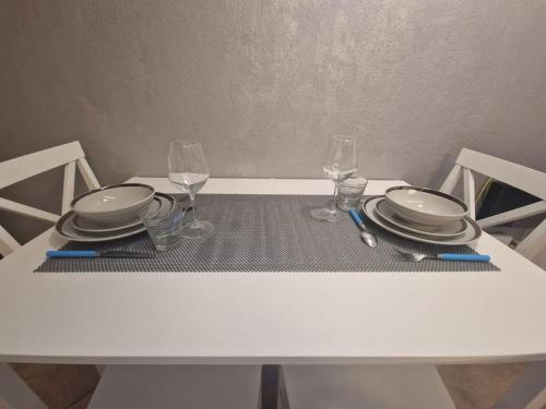 a white table with plates and glasses on it at Casa vacanza Castello in Cagliari