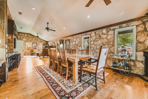 a kitchen and dining room with a table and chairs at The Camp Blanco by Lodgewell - Riverfront retreat 2 Homes, Bunk House, Game Room & more in Blanco