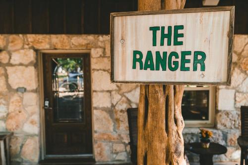 a sign that says the ranger on a wooden pole at The Camp Blanco by Lodgewell - Riverfront retreat 2 Homes, Bunk House, Game Room & more in Blanco