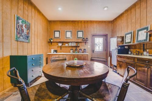 a kitchen with a wooden table and a refrigerator at The Camp Blanco by Lodgewell - Riverfront retreat 2 Homes, Bunk House, Game Room & more in Blanco