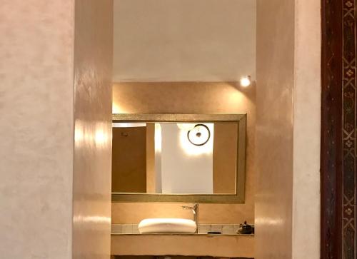 a bathroom with a sink and a mirror at Riad Dar Souika in Rabat
