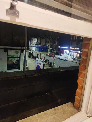 a view from a window of a street at night at East Finchley, Ensuite Room in London