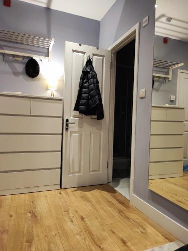 a kitchen with a door and a coat hanging on the door at East Finchley, Ensuite Room in London