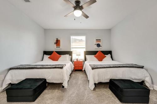 a bedroom with two beds and a ceiling fan at Little elm 5BR Gem Pool Spa Firepit Game Room in Little Elm