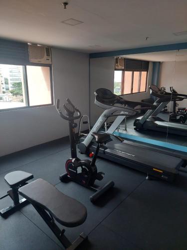a gym with two exercise bikes and a mirror at Flat Borges Lagoa Vl Mariana Ibirapuera com garagem UH1007 in Sao Paulo