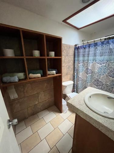 a bathroom with a sink and a toilet at La Perla de Cobano in Puntarenas