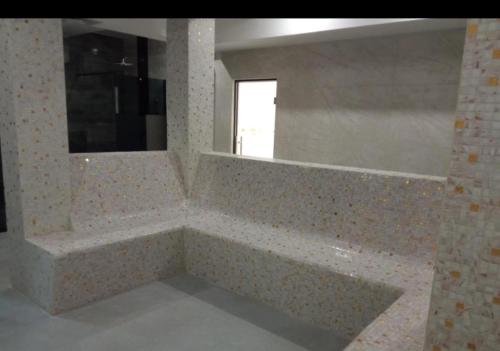 a bathroom with a large tub and a mirror at Apartmani K&V in Veliko Gradište