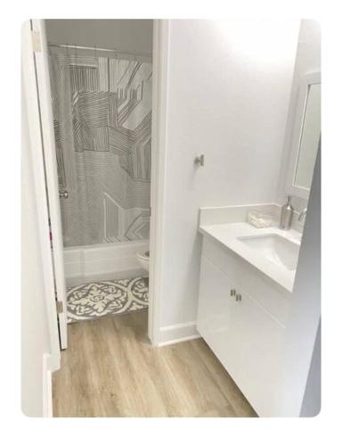 a white bathroom with a shower and a sink at Gorgeous 1 bedroom Beverly Hills in Los Angeles