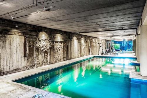 a swimming pool with blue water in a building at Amplio Loft en Puerto Madero a pasos del Puente de la Mujer y Casa Rosada in Buenos Aires