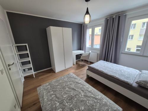 a small bedroom with two beds and a desk at Aus alt wird neu - Apartment in Essener City in Essen