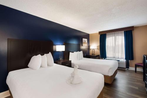 a hotel room with two beds and a window at Best Western Springfield in Springfield