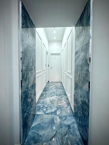 a hallway with a blue marble floor in a house at MARVIT CENTRAL LUXURY in Naples