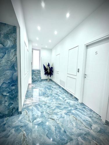 a hallway with a blue marble floor in a building at MARVIT CENTRAL LUXURY in Naples