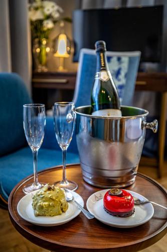 a table with two plates of food and a bottle of wine at Hotel Duomo Firenze in Florence