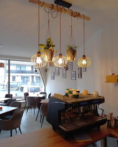 a dining room with a table and some lights at LASKARA Garden Apartment by Prague Forest in Nové Jirny