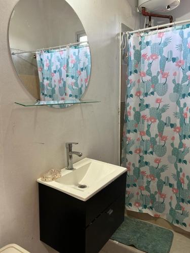 a bathroom with a sink and a mirror at Cabañas Autodromo in Termas de Río Hondo