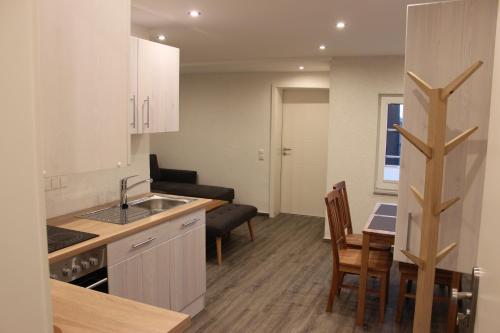a kitchen with a sink and a table with chairs at Ferienhaus Kunz in Fehmarn