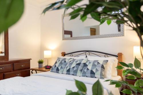 a bedroom with a bed and two mirrors on the wall at J. B Apartamentos in Santo Domingo
