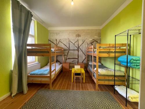 a room with three bunk beds and a window at Stay in a Historical Train Station up to 10 beds in Halbe