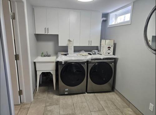 uma cozinha com uma máquina de lavar roupa e um lavatório em Private Apartment in Ottawa near the Ottawa hospital em Ottawa