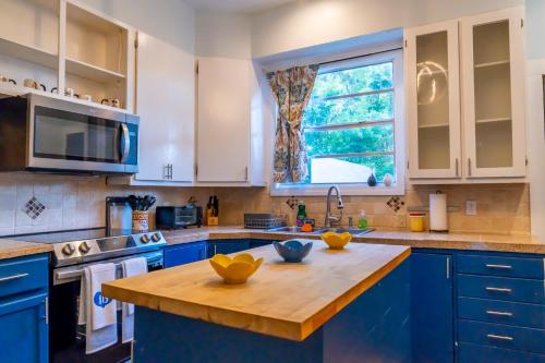 a kitchen with blue cabinets and a wooden counter top at 5Beds-Walk to Bars and Shops-On Free Trolley Route in Tampa