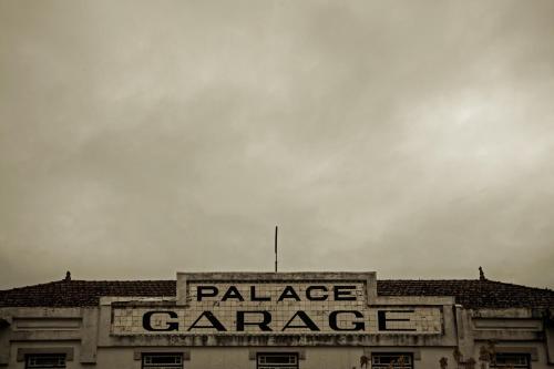 a large palace garage sign on top of a building at Curia Palace Hotel & Spa in Curia
