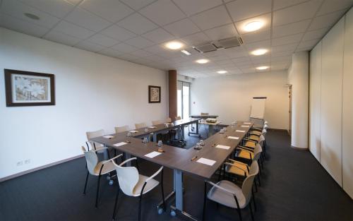 a large conference room with a long table and chairs at Mercure Agen Centre in Agen